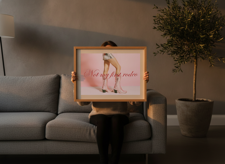 Person holding modern wall art print in a luxe living room