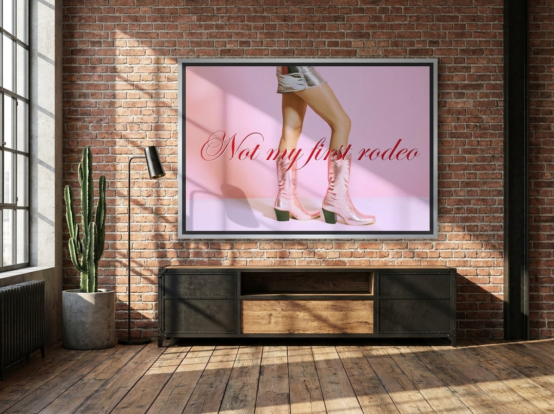 Oversized statement canvas wall art with a silver leaf surround styled on the wall in an industrial loft living room