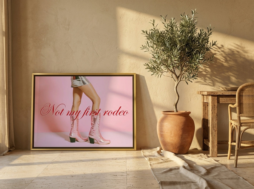 Canvas wall art with a gold leaf surround leaning against the wall in a Mediterranean bedroom