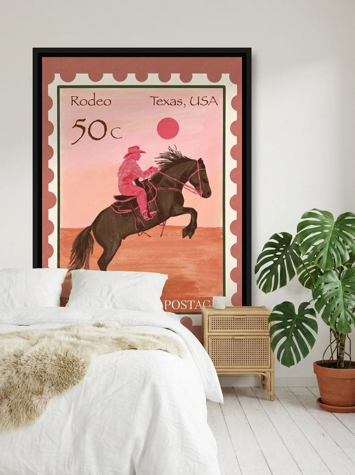 Canvas wall art with a black surround styled on the wall in a bright Scandinavian bedroom