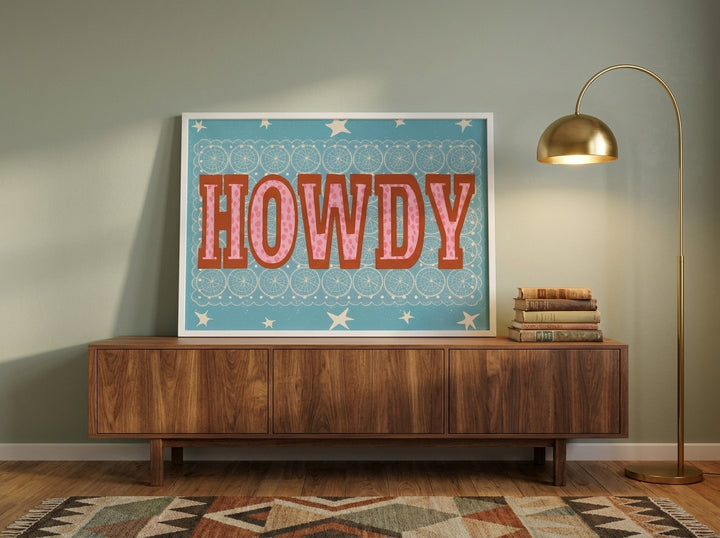 Modern wall art print standing on a sideboard in a mid-century bedroom