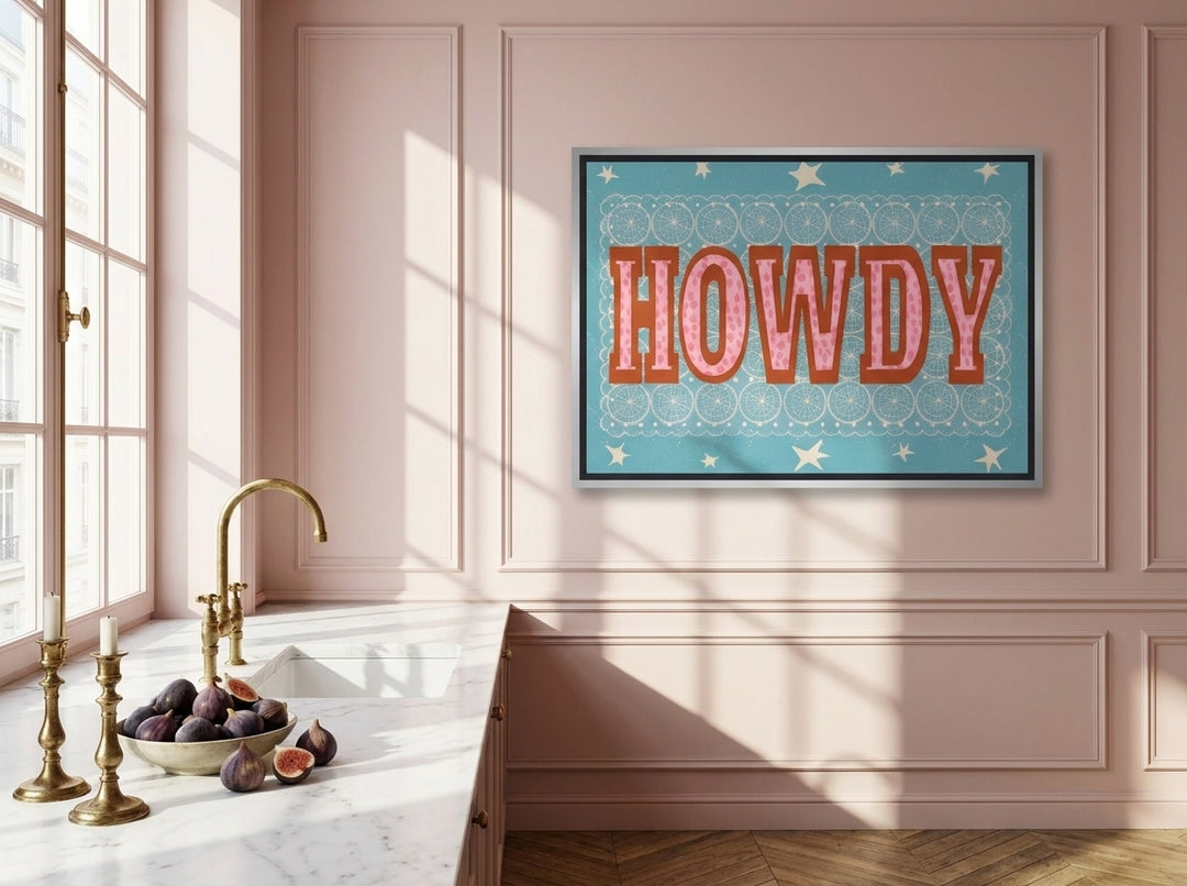 Canvas wall art with a silver leaf surround styled on the wall in a Parisian kitchen