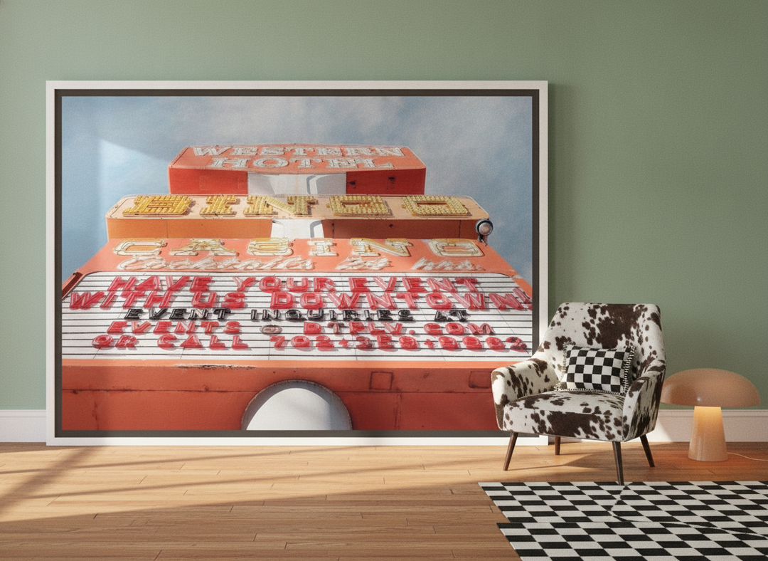 Oversized statement canvas wall art with a white surround leaning against the wall in a colourful eclectic bedroom