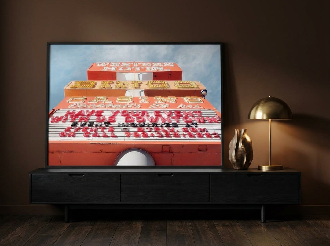Modern wall art print standing on a console in a moody living room