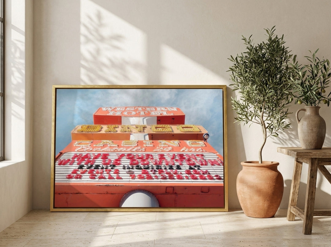 Canvas wall art with a gold leaf surround leaning against the wall in a Mediterranean home office