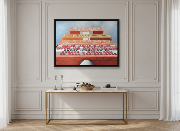 Canvas wall art with a black surround styled on the wall in a Parisian living room