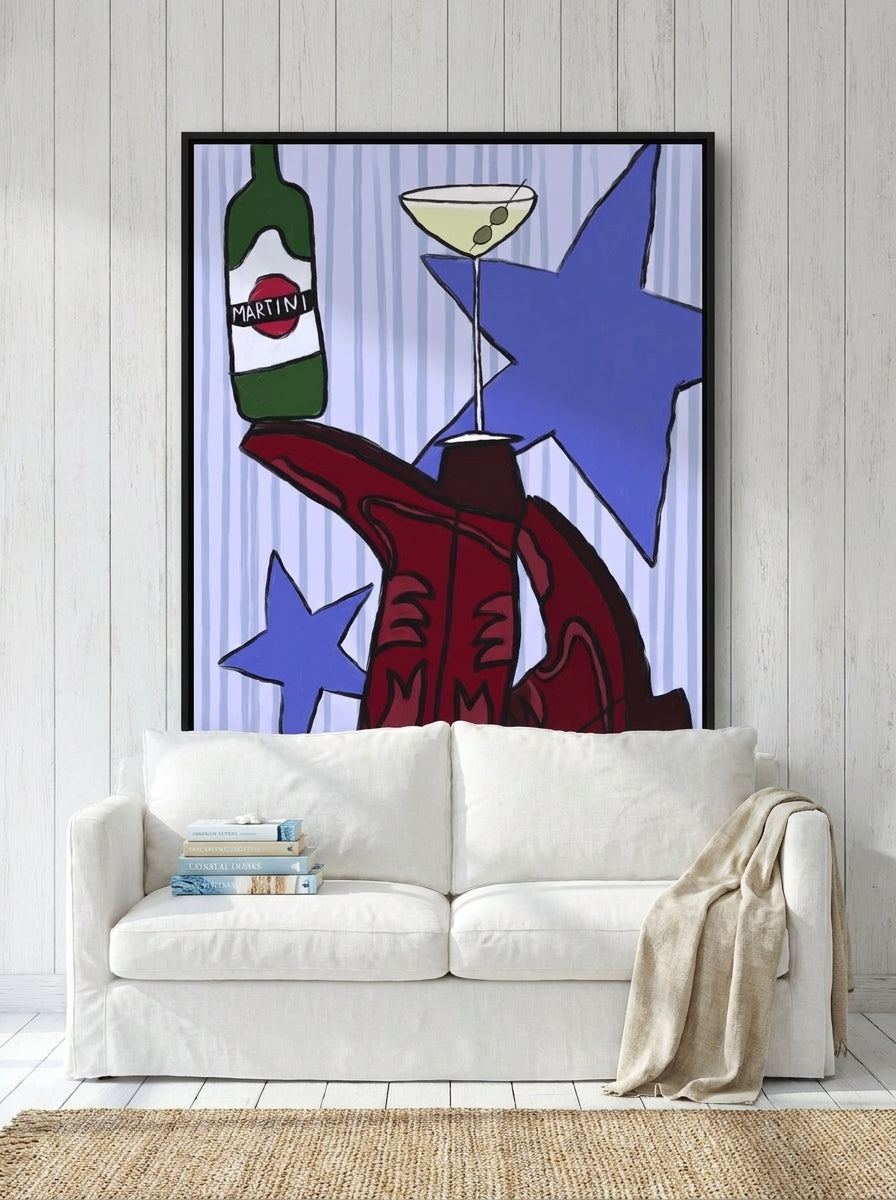 Canvas wall art with a black surround styled on the wall in a coastal living room