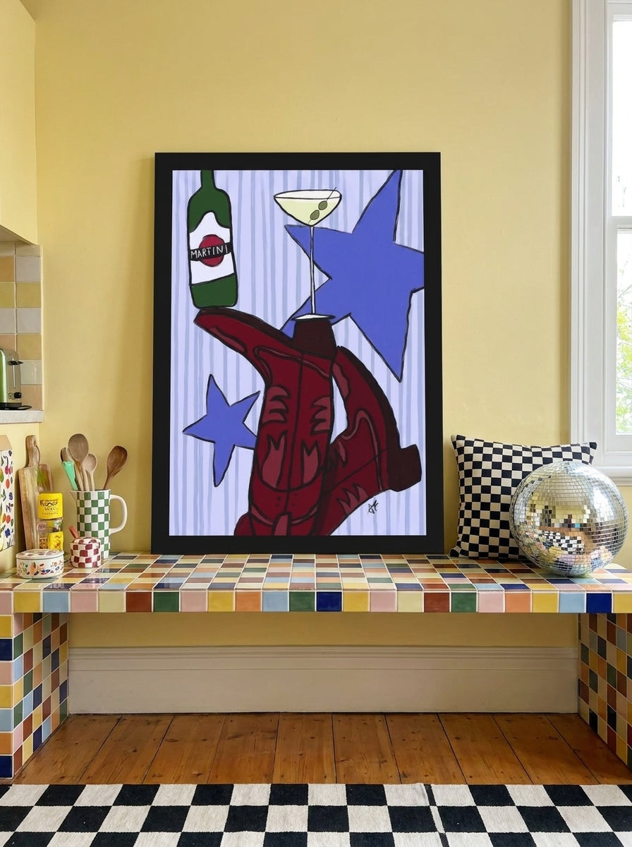 Modern wall art print standing on a kitchen bench in a colourful eclectic kitchen
