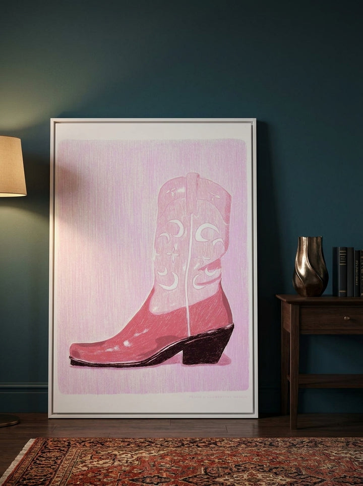 Oversized statement canvas wall art with a white surround leaning against the wall in a moody living room