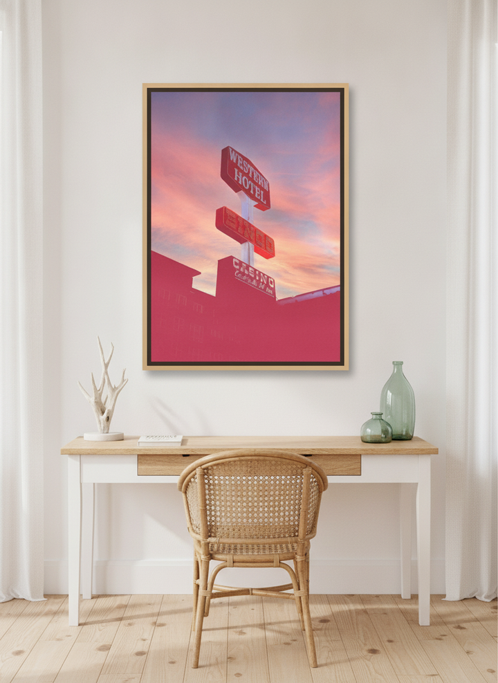 Canvas wall art with a natural timber surround styled on the wall in a coastal home office
