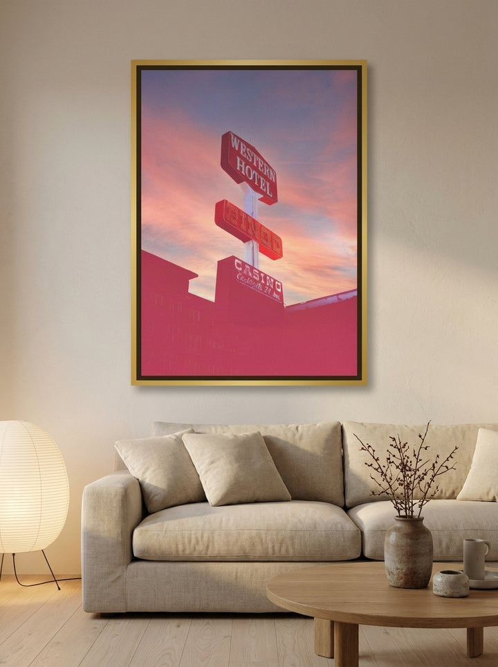 Oversized statement canvas wall art with a gold leaf surround styled on the wall in a warm Japandi living room