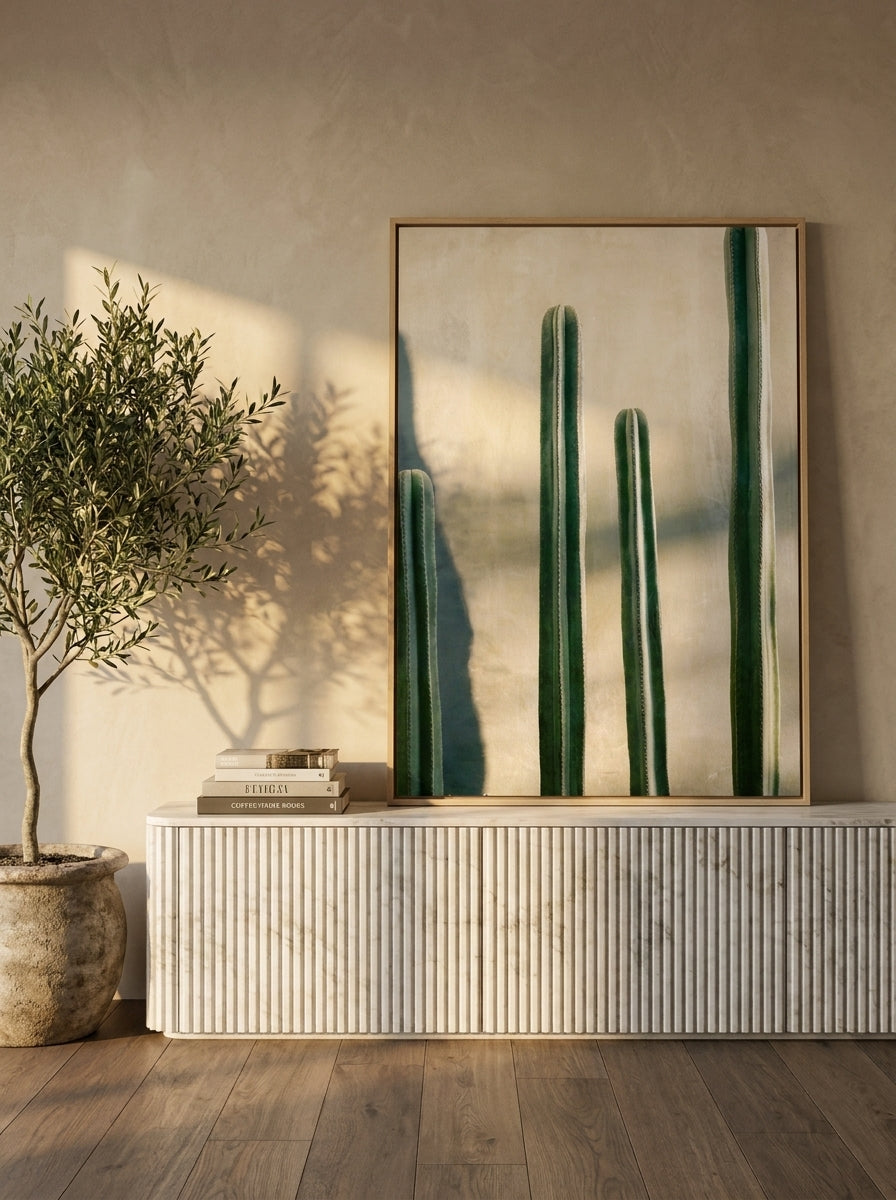 Canvas wall art with a natural timber surround standing on a sideboard in a luxe bathroom