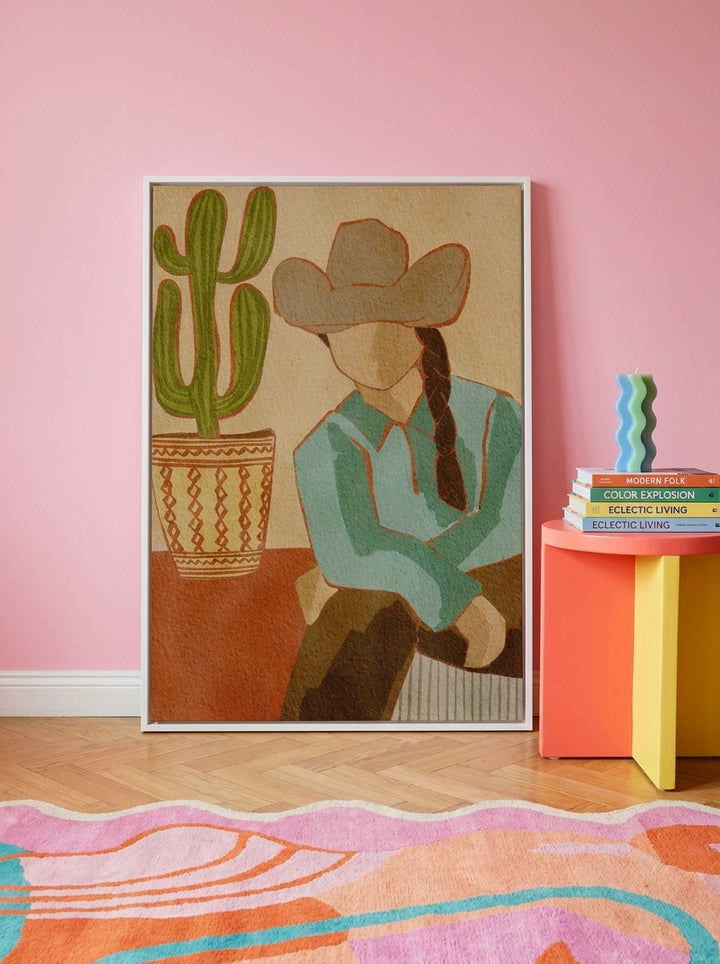 Canvas wall art with a white surround standing on a side table in a colourful eclectic living room