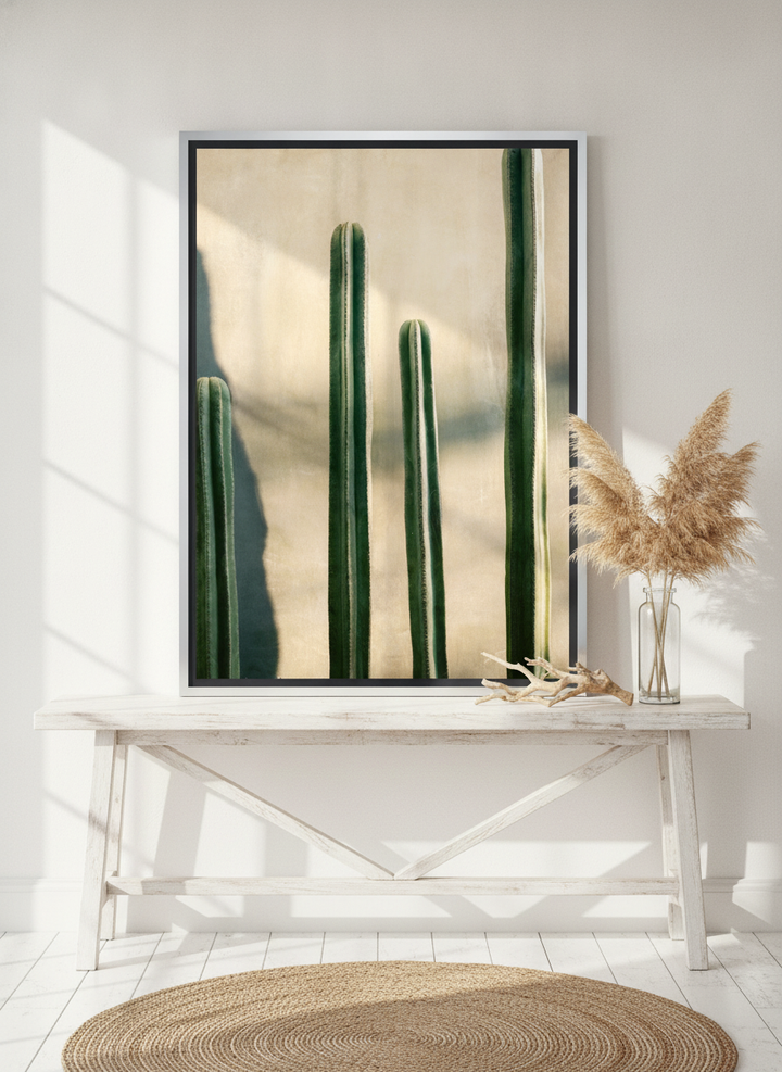Canvas wall art with a silver leaf surround standing on a console in a coastal bathroom