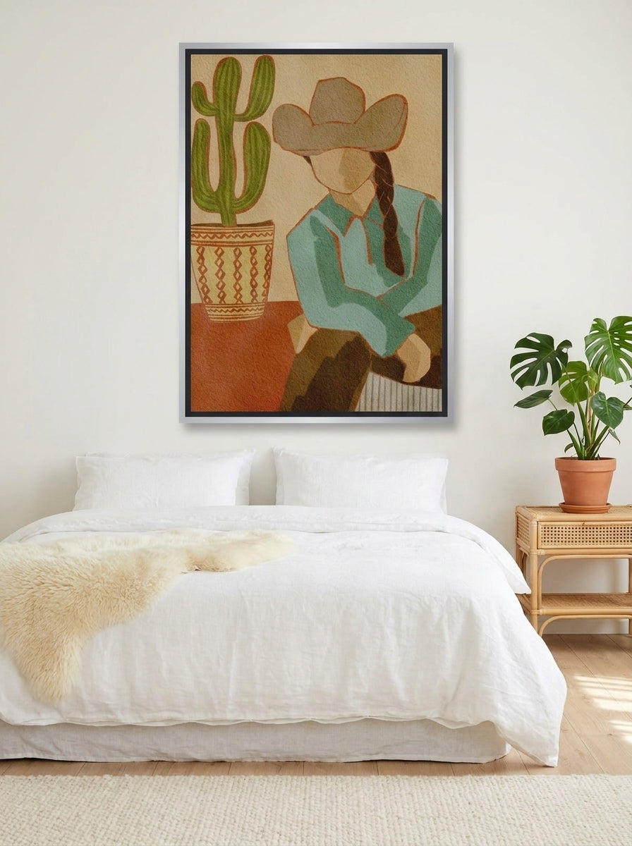 Canvas wall art with a silver leaf surround styled on the wall in a bright Scandinavian bedroom