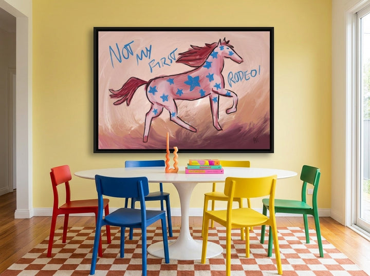 Oversized statement canvas wall art with a black surround styled on the wall in a colourful eclectic dining room