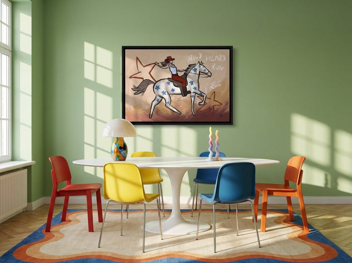 Canvas wall art with a black surround styled on the wall in a colourful eclectic dining room