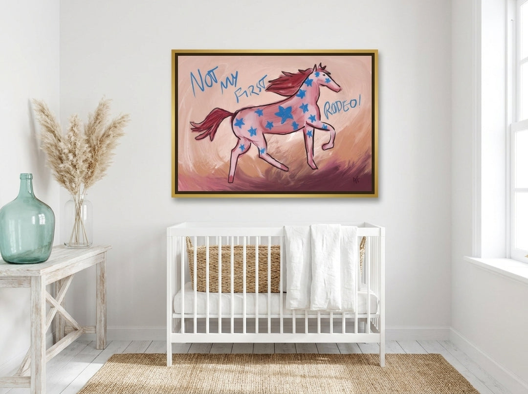 Canvas wall art with a gold leaf surround styled on the wall in a coastal nursery