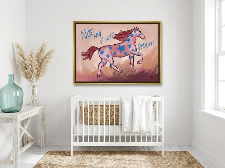 Canvas wall art with a gold leaf surround styled on the wall in a coastal nursery