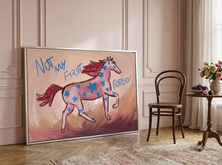 Oversized statement canvas wall art with a silver leaf surround leaning against the wall in a Parisian living room