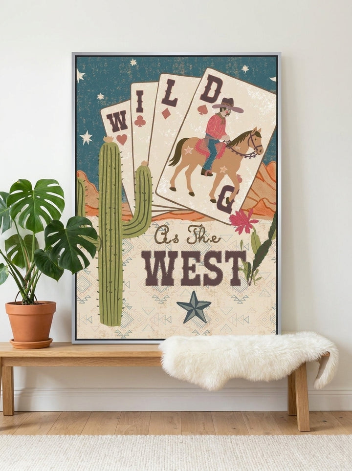 Canvas wall art with a silver leaf surround standing on a bench in a bright Scandinavian bedroom