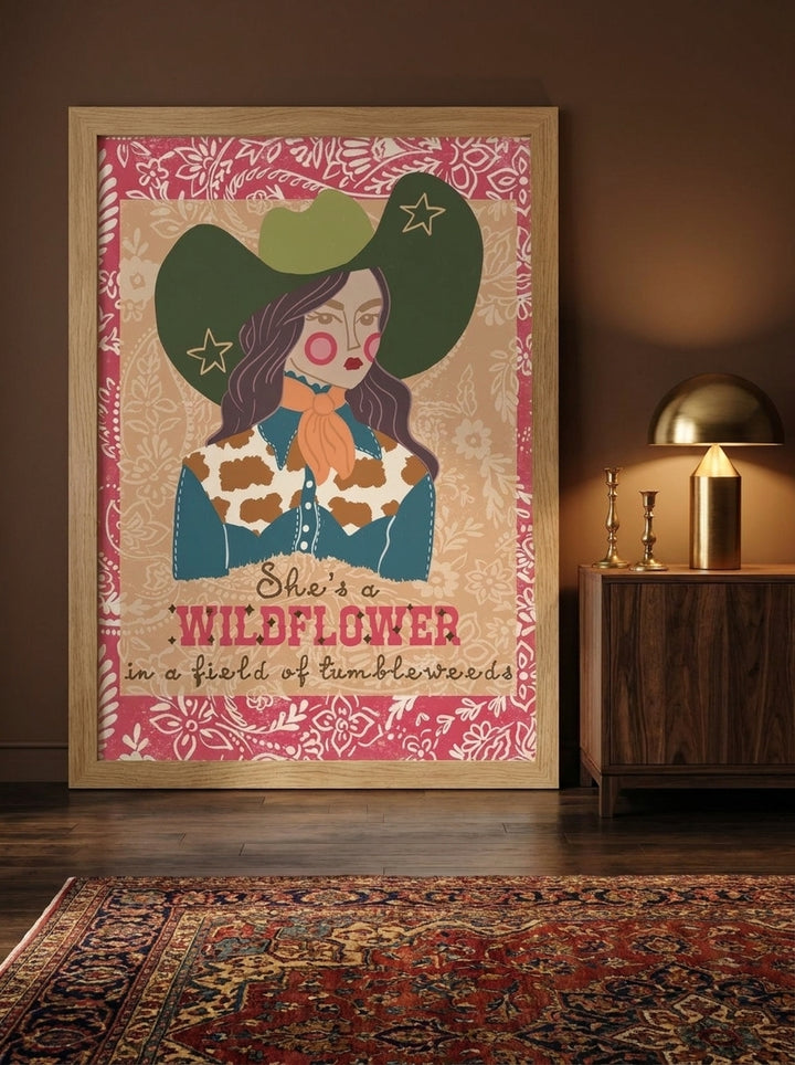 Modern wall art print standing on a sideboard in a moody home office