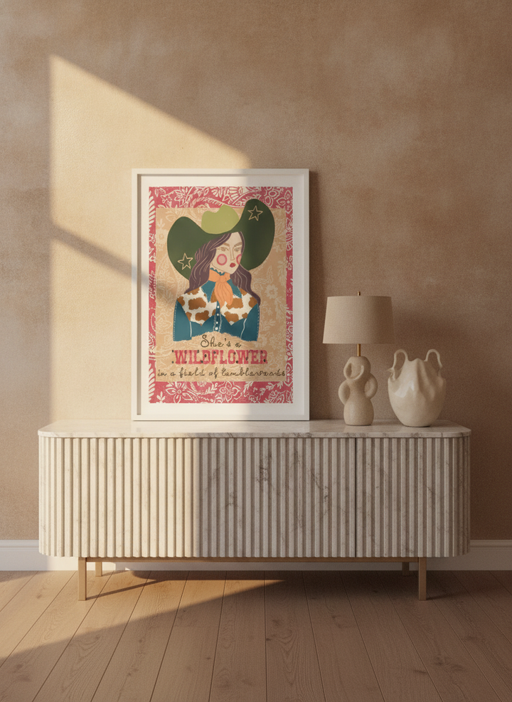 Modern wall art print standing on a sideboard in a luxe bedroom