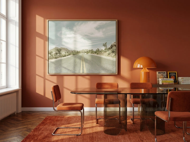 Oversized statement canvas wall art with a natural timber surround styled on the wall in a retro 70s dining room