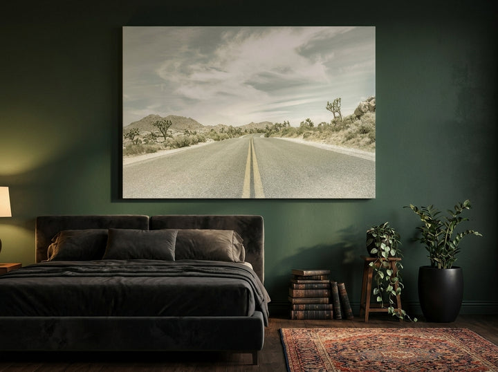 Stretched canvas wall art styled on the wall in a moody bedroom