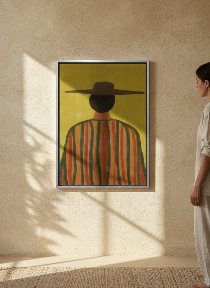 Person holding canvas wall art with a silver leaf surround in a Mediterranean living room