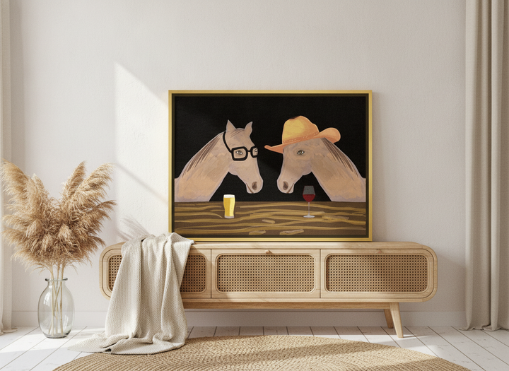 Canvas wall art with a gold leaf surround standing on a sideboard in a coastal living room