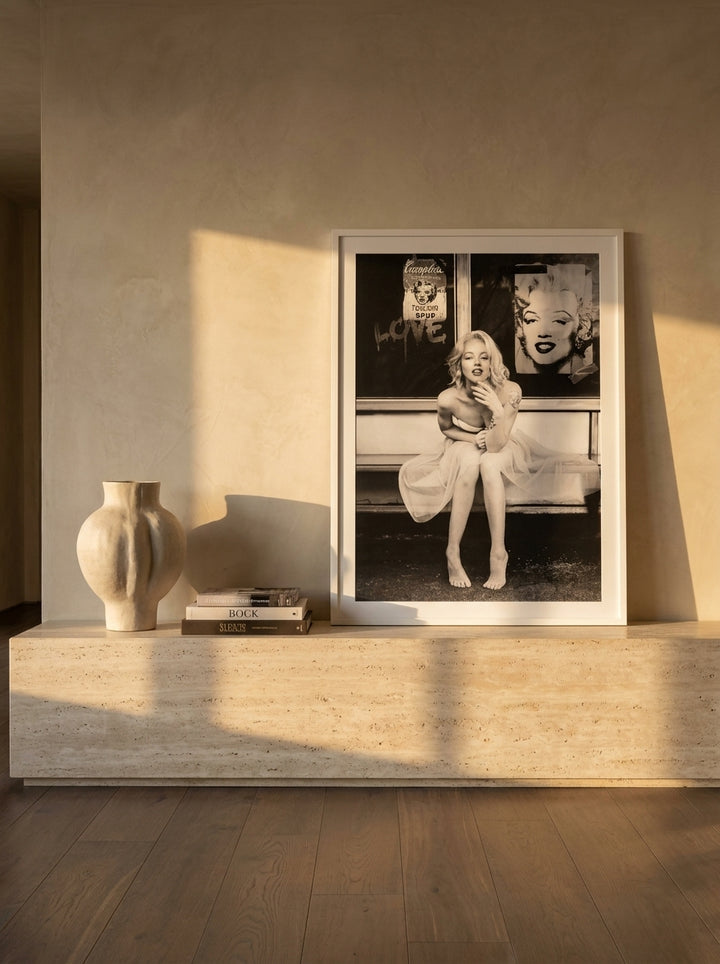 Modern wall art print standing on a console in a luxe dining room