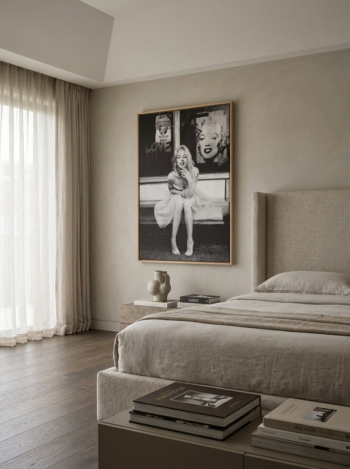Oversized statement canvas wall art with a natural timber surround styled on the wall in a luxe bedroom