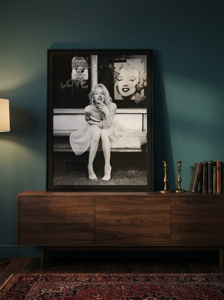 Modern wall art print standing on a sideboard in a moody home office