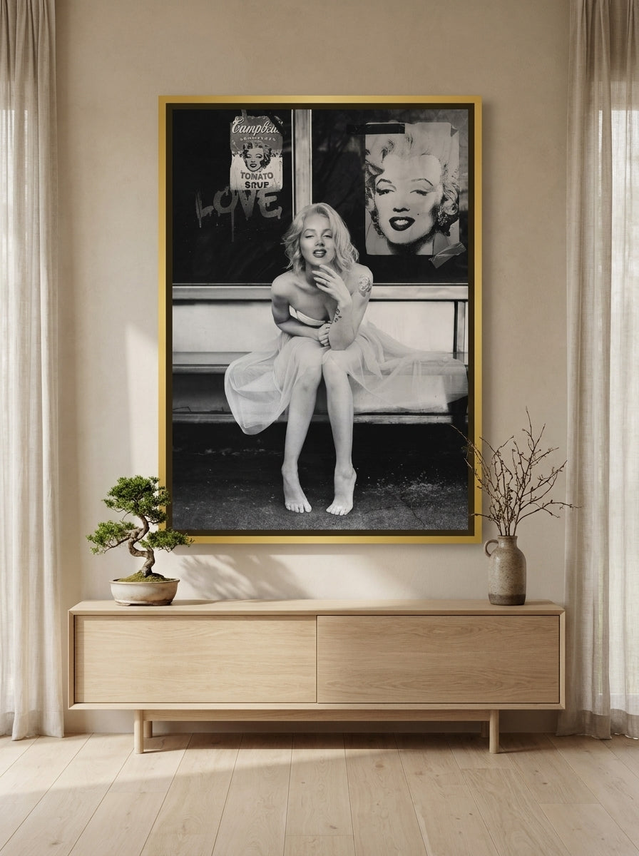 Oversized statement canvas wall art with a gold leaf surround styled on the wall in a warm Japandi living room