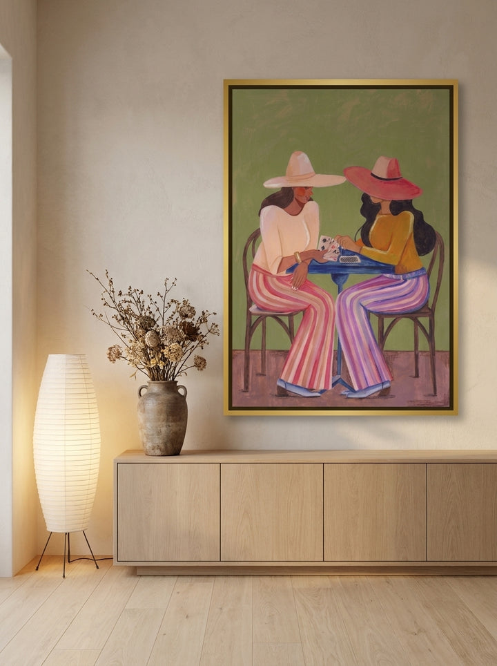 Oversized statement canvas wall art with a gold leaf surround styled on the wall in a warm Japandi living room