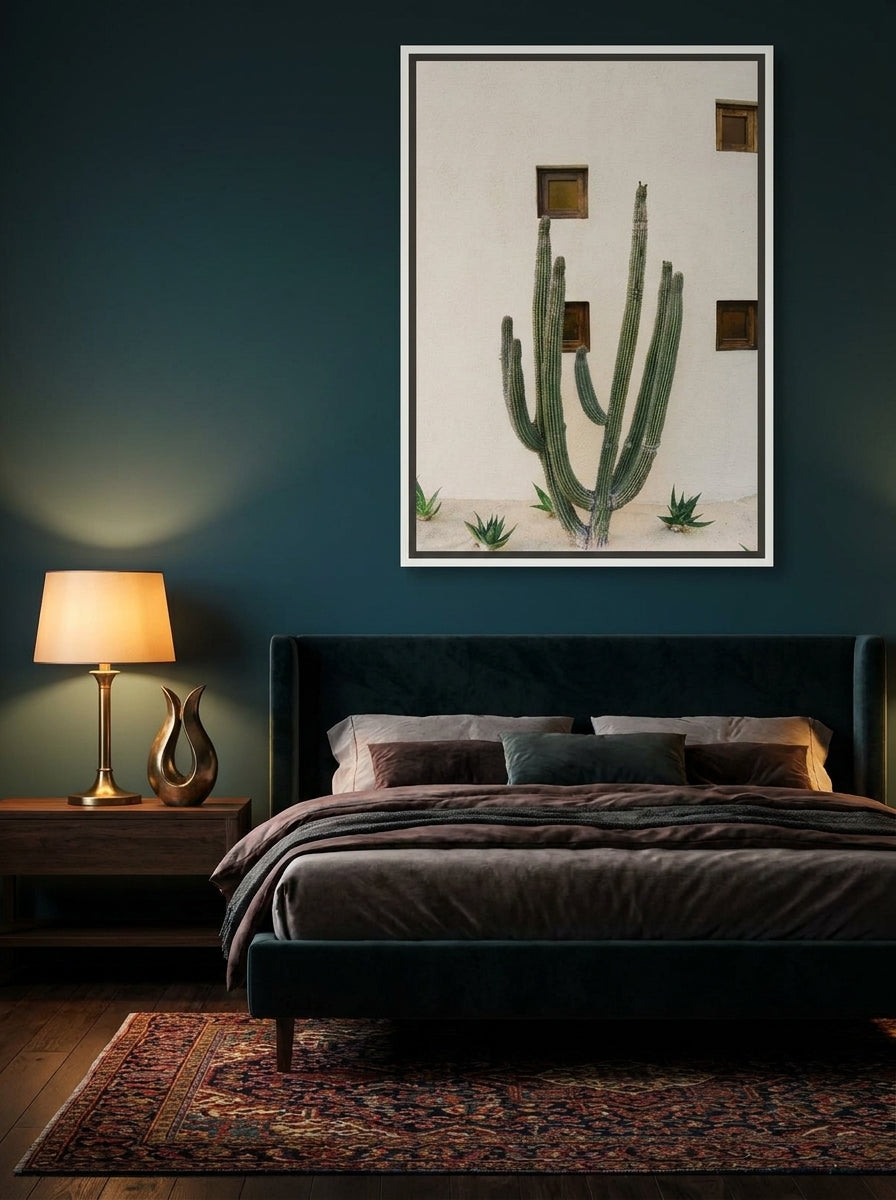 Canvas wall art with a white surround styled on the wall in a moody bedroom