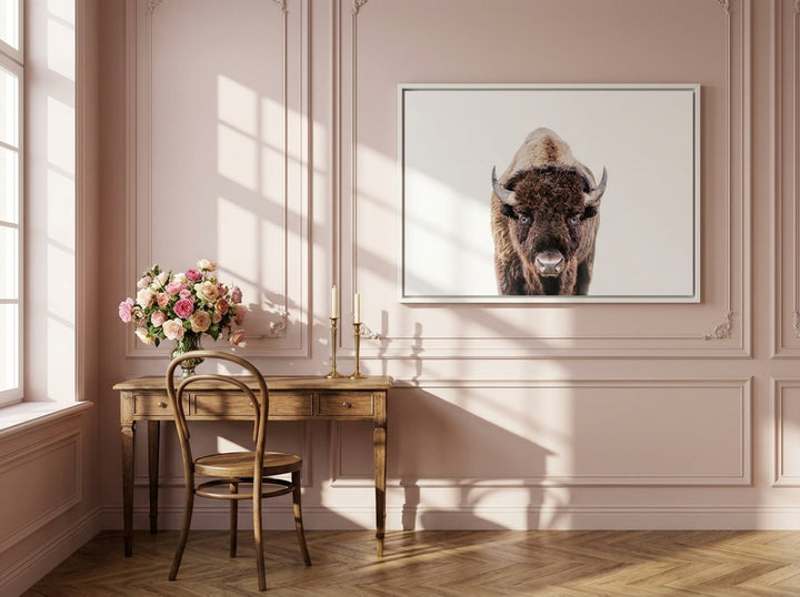 Canvas wall art with a white surround styled on the wall in a Parisian home office