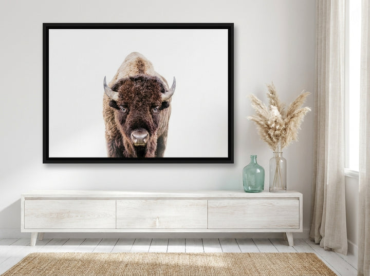 Oversized statement canvas wall art with a black surround styled on the wall in a coastal living room