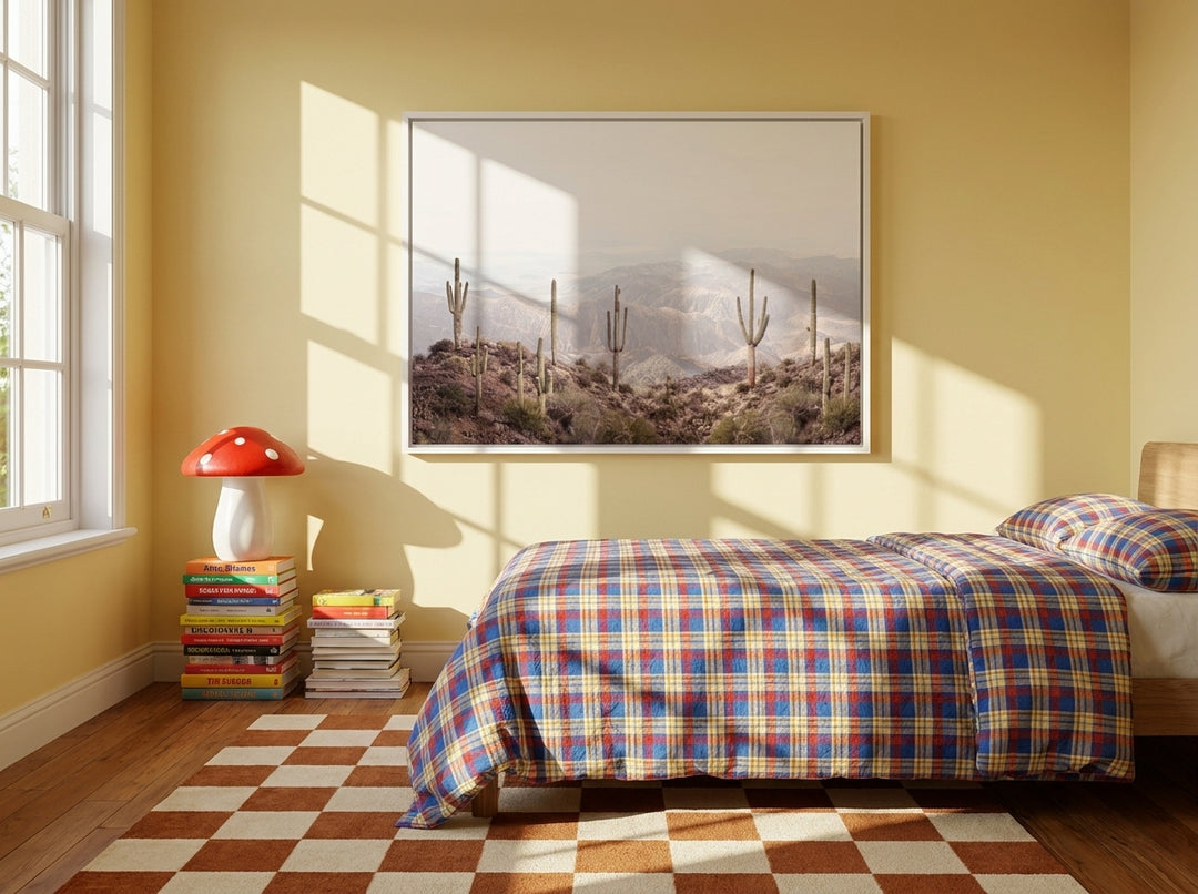 Canvas wall art with a white surround styled on the wall in a colourful eclectic bedroom
