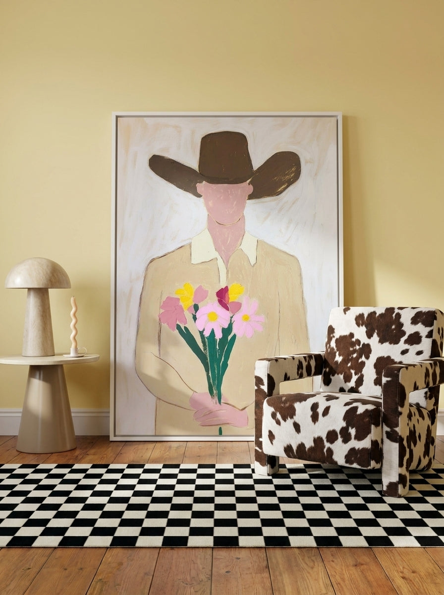 Oversized statement canvas wall art with a white surround leaning against the wall in a colourful eclectic dining room