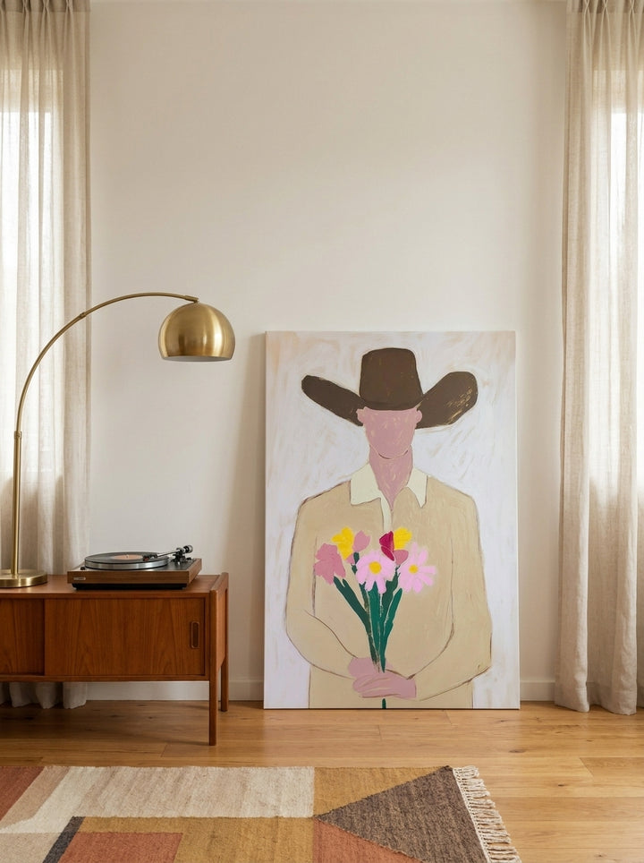 Stretched canvas wall art leaning against the wall in a mid-century bedroom