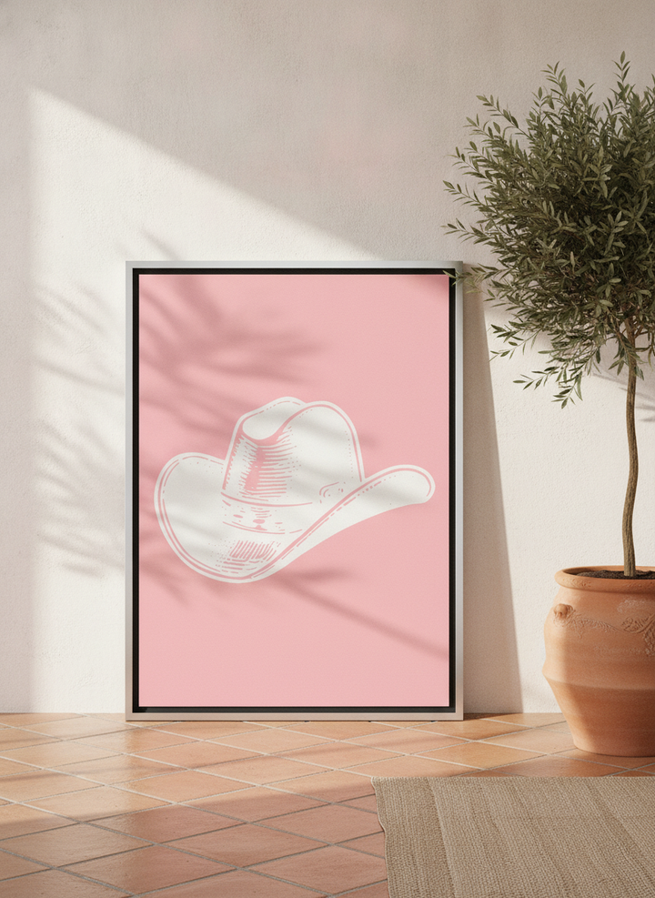 Canvas wall art with a silver leaf surround leaning against the wall in a Mediterranean bedroom