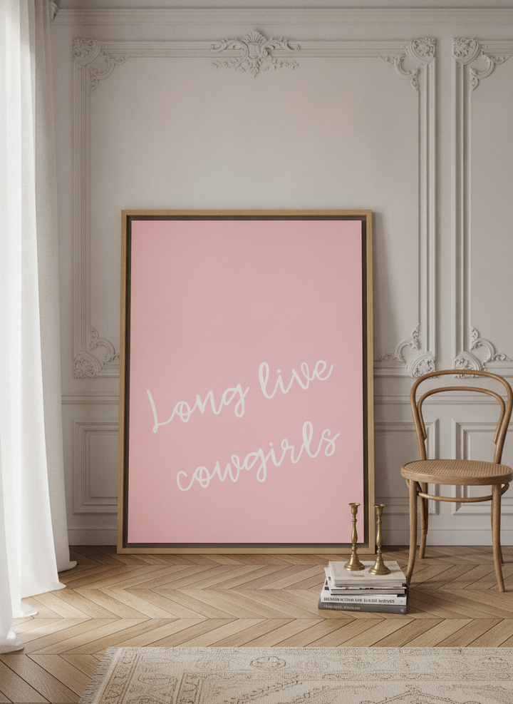Oversized statement canvas wall art with a natural timber surround leaning against the wall in a Parisian living room