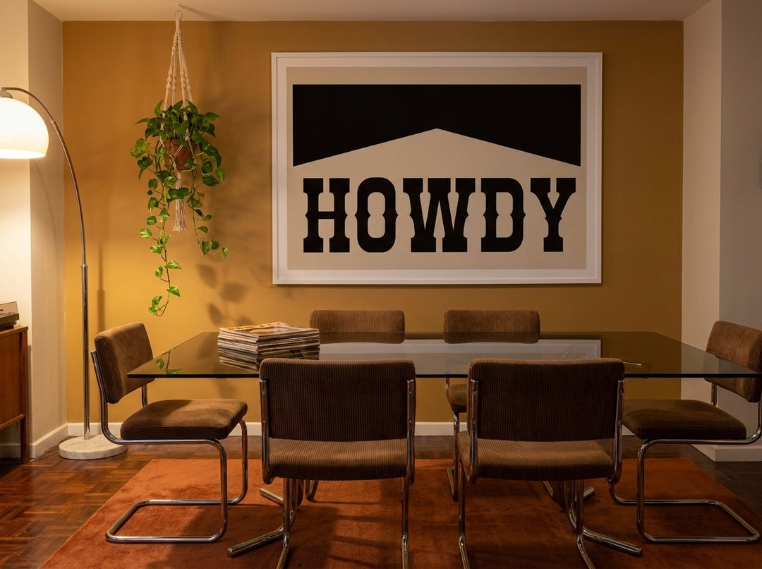 Oversized statement modern wall art print styled on the wall in a retro 70s dining room