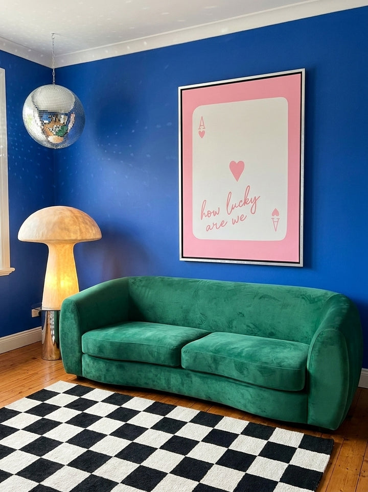 Canvas wall art with a silver leaf surround styled on the wall in a colourful eclectic living room