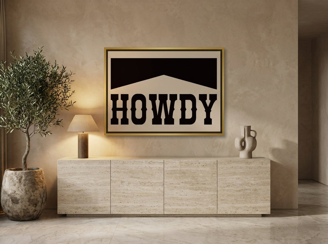 Canvas wall art with a gold leaf surround styled on the wall in a luxe living room