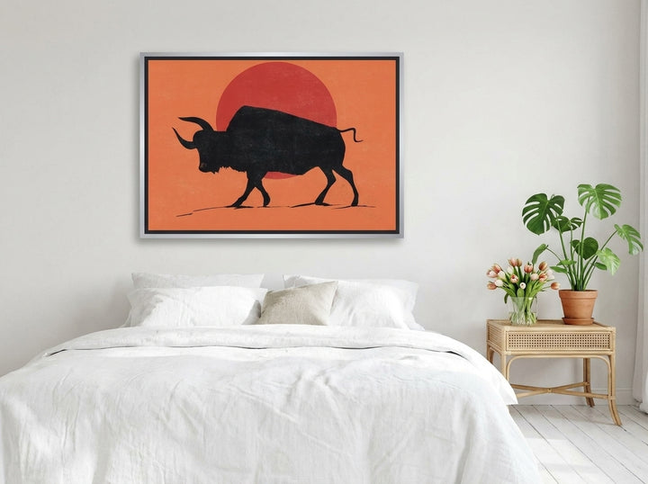 Canvas wall art with a silver leaf surround styled on the wall in a bright Scandinavian bedroom