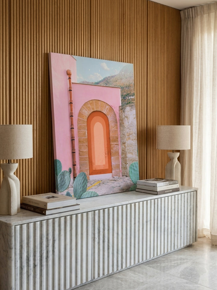 Stretched canvas wall art standing on a sideboard in a luxe bedroom