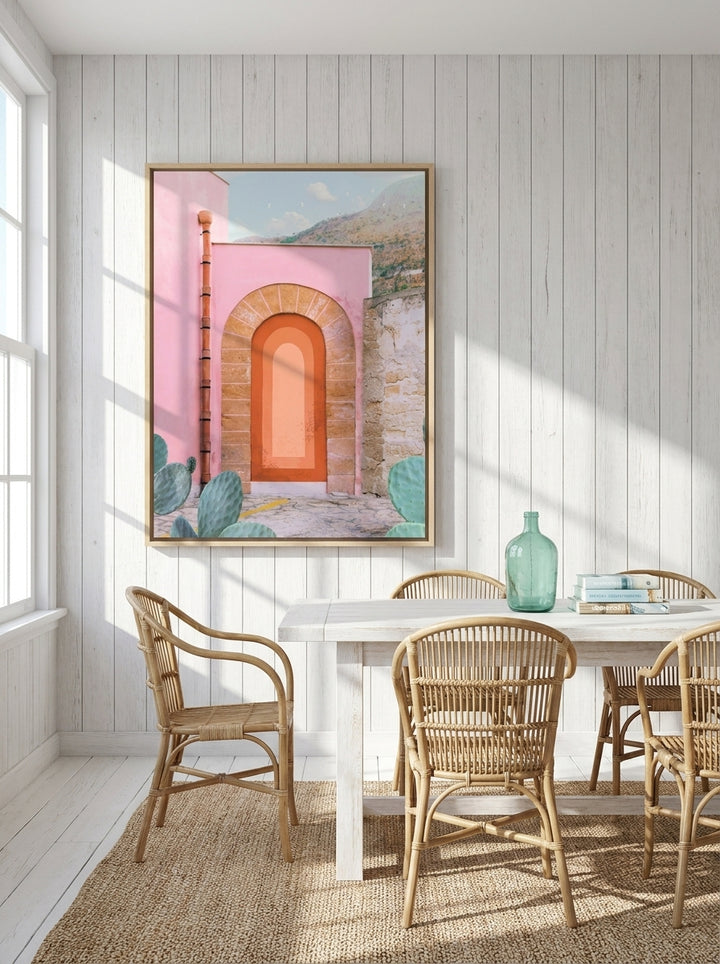 Oversized statement canvas wall art with a natural timber surround styled on the wall in a coastal dining room